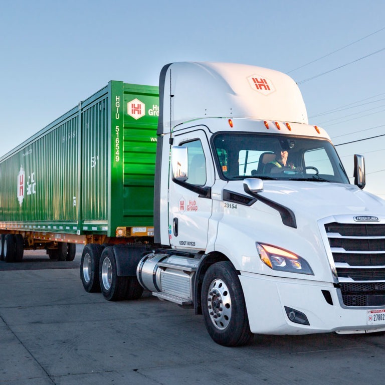 Hub Group driver in green Hub Group providing dedicated trucking services