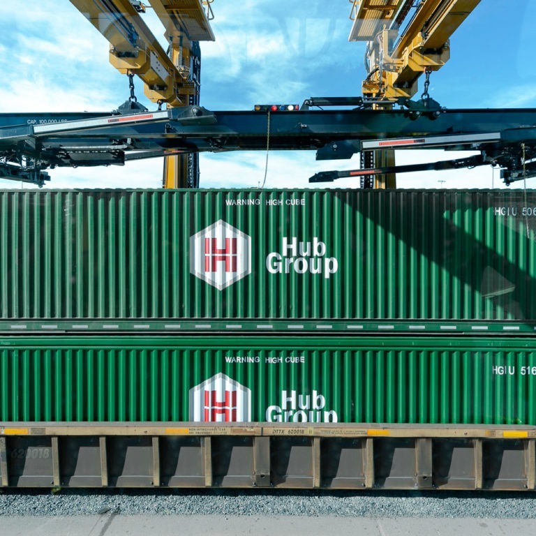 Hub Group's green intermodal transportation freight containers stacked on top each other